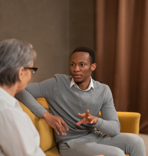 a man and a woman talking on a couch